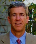 Headshot of Dave Porter, white male in his fifties, wearing a tan suit and tie.